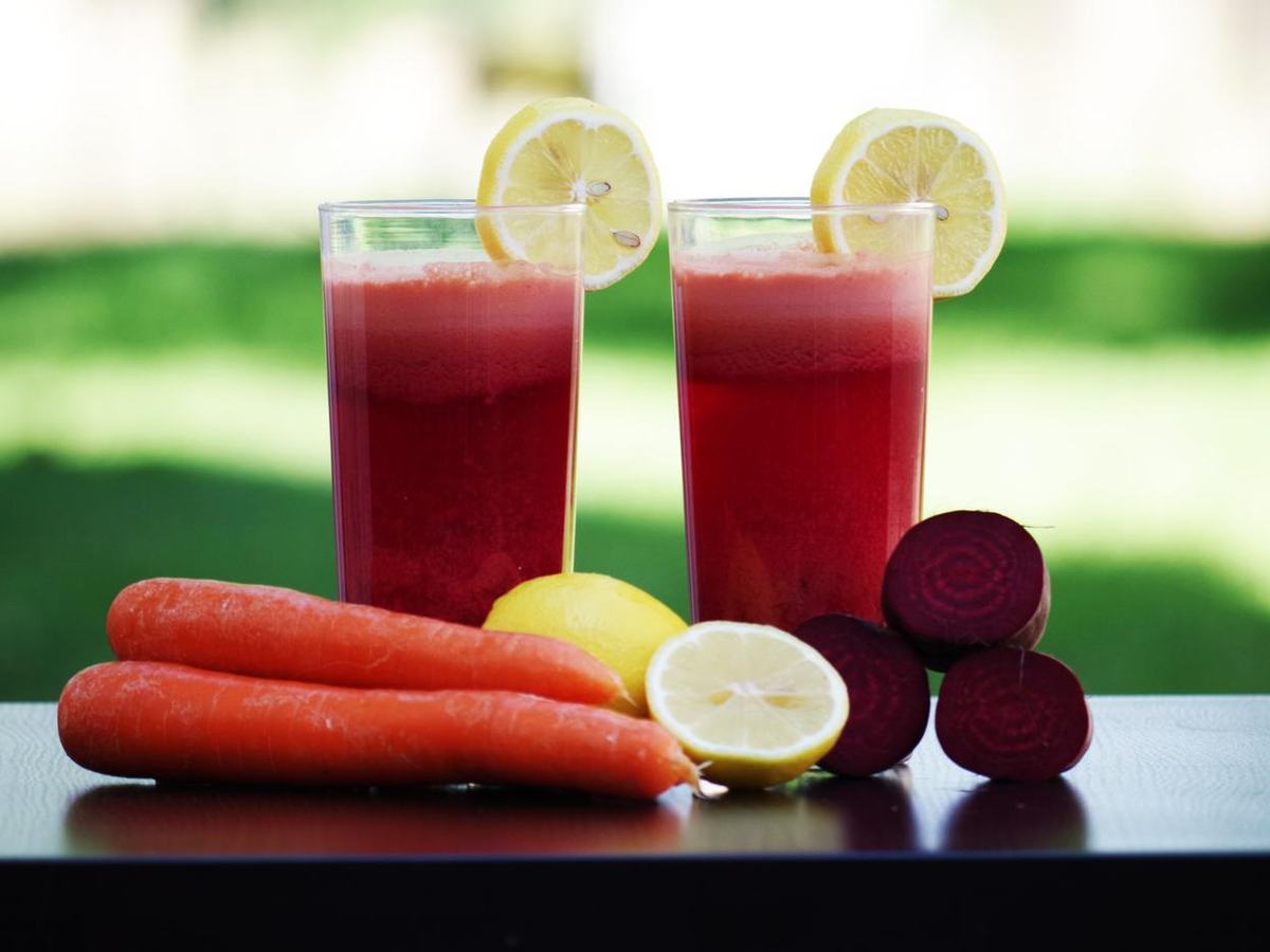 Fresh beet, carrot and lemon juice with whole vegetables