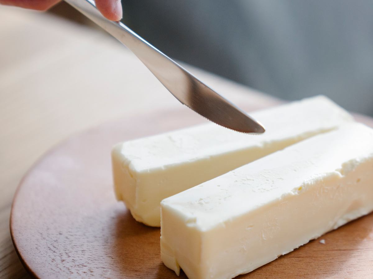 Fresh butter block being sliced