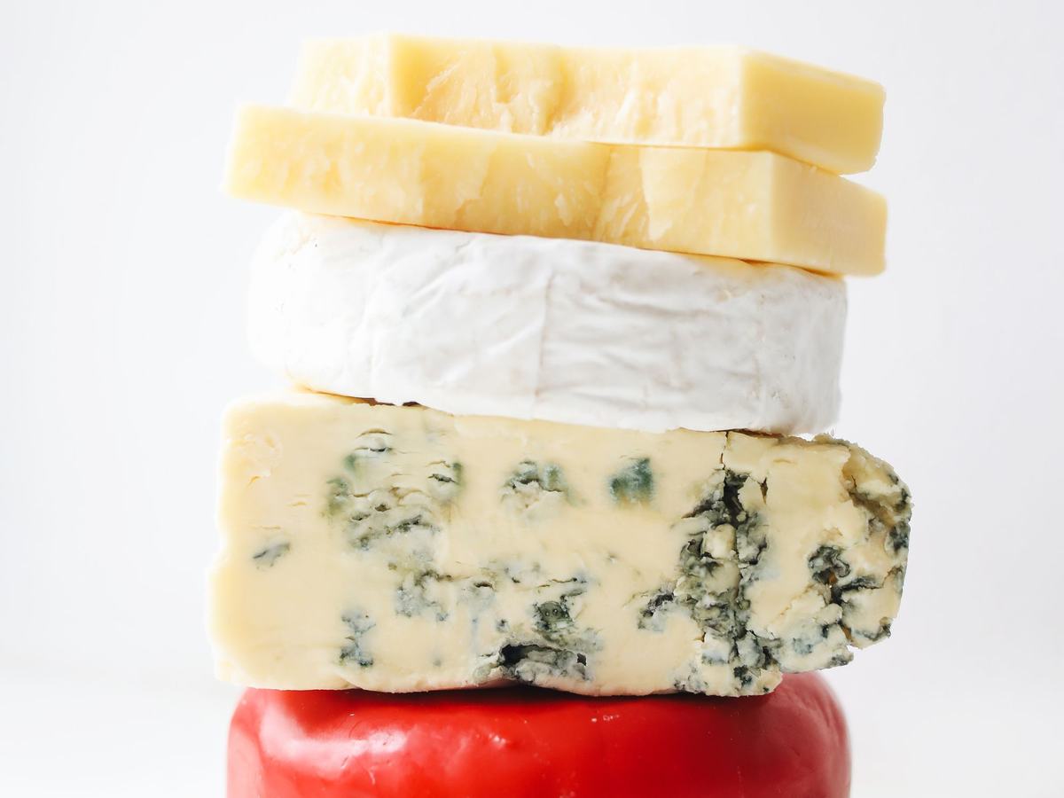 A selection of cheese varieties stacked