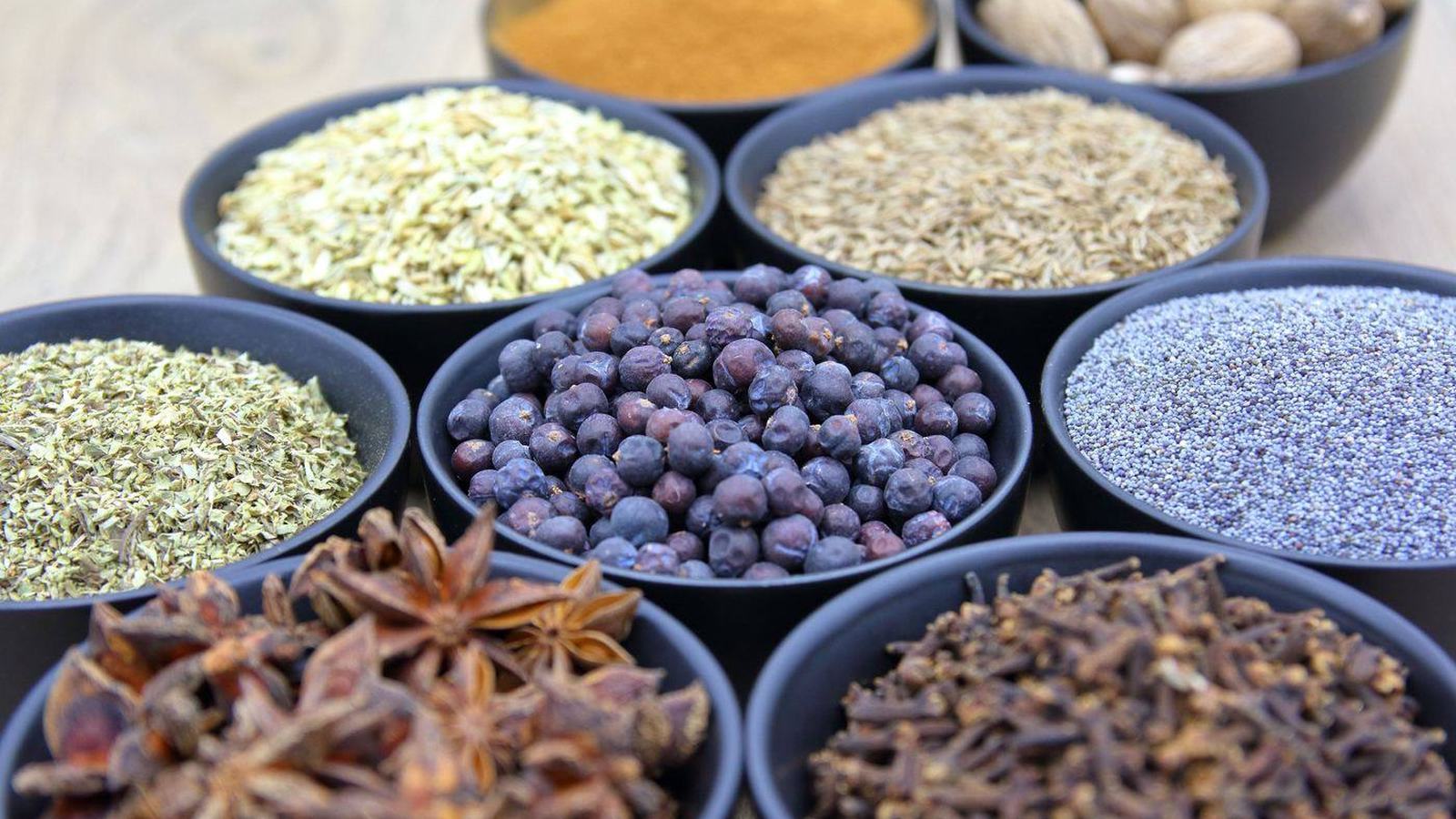 Assorted whole Pakistani spices in bowls